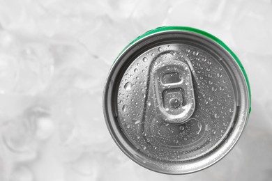 Energy drink in wet can on light background, top view. Space for text