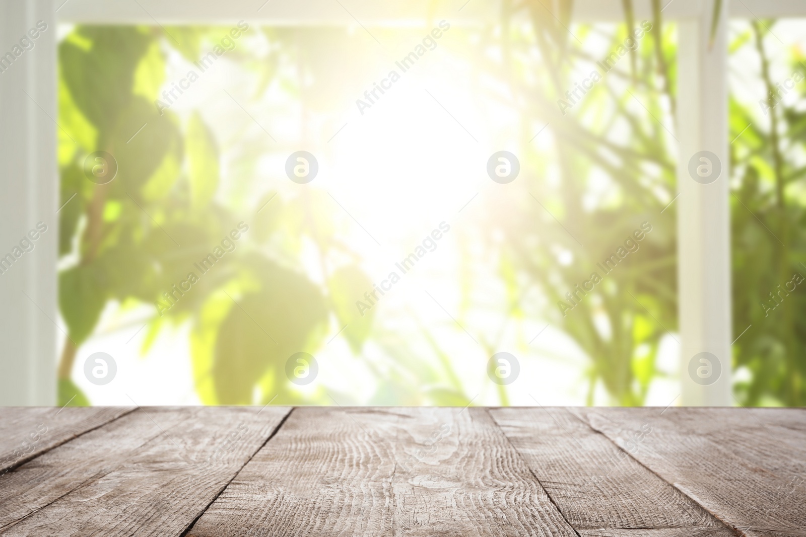 Image of Empty wooden table in front of window. Sunny morning 