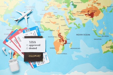 Photo of Flat lay composition with passport and tickets on world map. Space for text