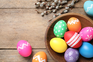 Flat lay composition with Easter eggs on wooden background. Space for text