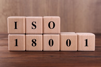 Cubes with abbreviation ISO and number 18001 on wooden table