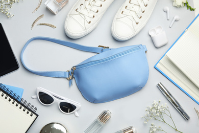 Photo of Flat lay composition with stylish woman's bag and accessories on light grey background