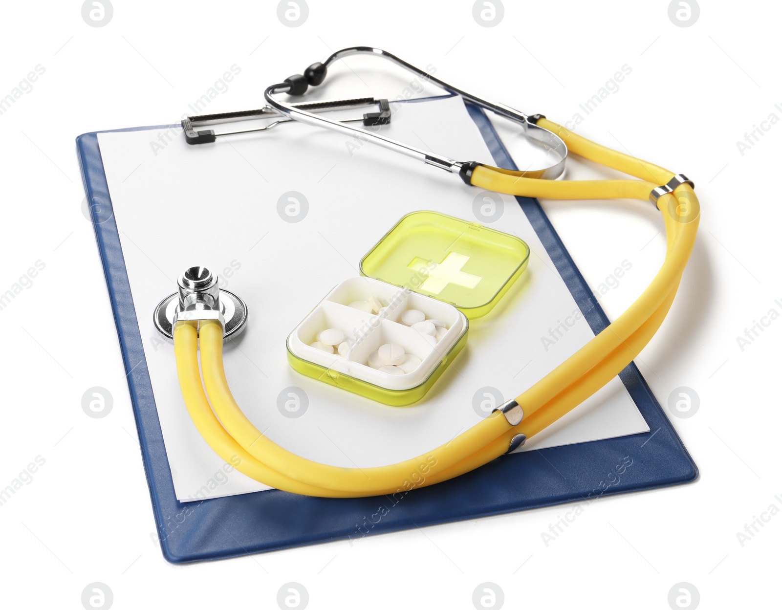 Photo of Clipboard, plastic pill box and stethoscope on white background