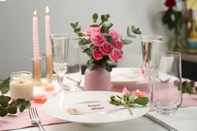 Romantic table setting with flowers and candles