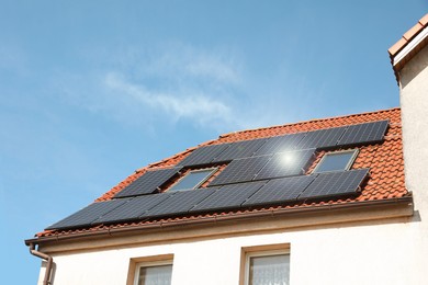 House with installed solar panels on roof. Alternative energy