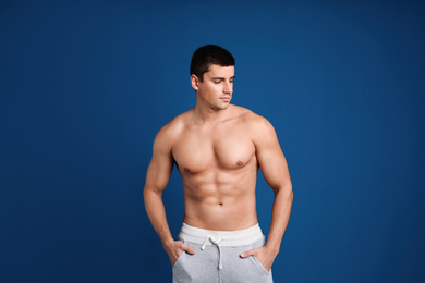 Photo of Man with sexy body on blue background