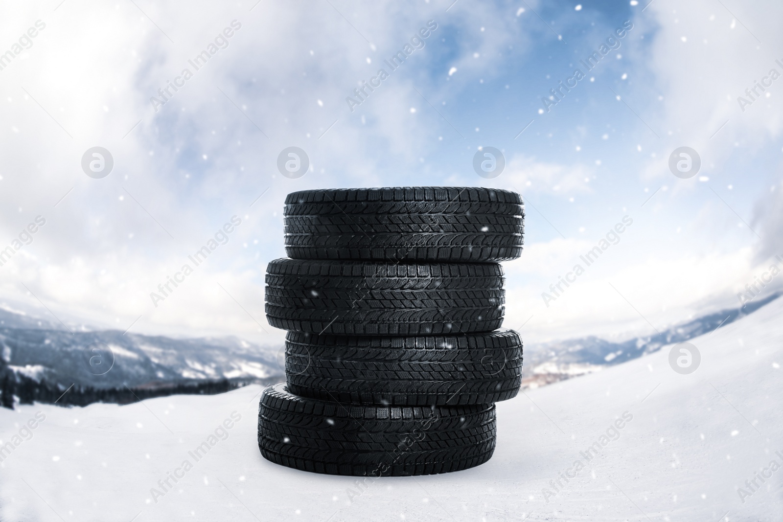 Image of Set of new winter tires outdoors on snow