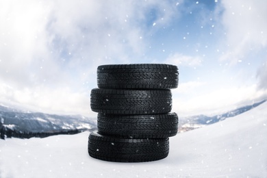 Image of Set of new winter tires outdoors on snow