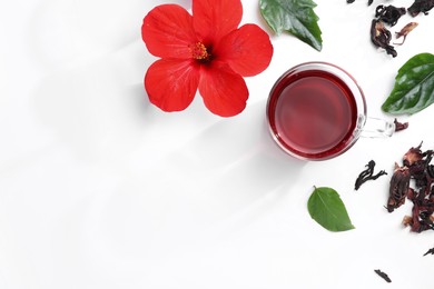 Flat lay composition with delicious hibiscus tea on white background, space for text