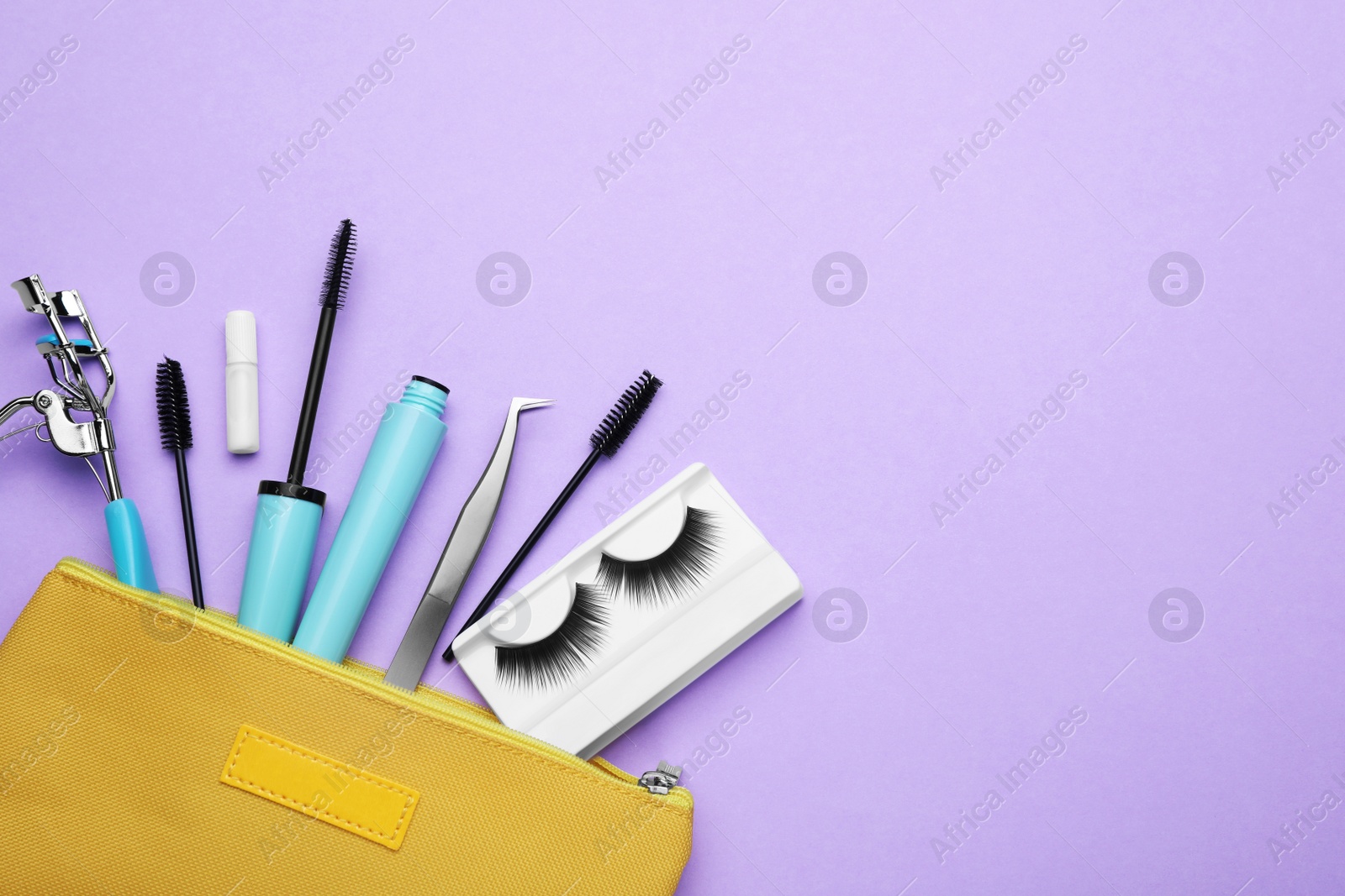 Photo of Flat lay composition with fake eyelashes, brushes and tools on lilac background. Space for text