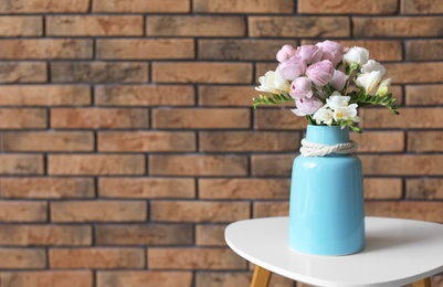 Photo of Vase with beautiful flowers on table indoors