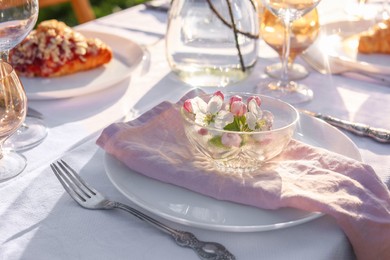 Photo of Stylish table setting with beautiful spring flowers in garden