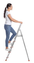 Young woman climbing up metal ladder on white background