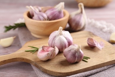 Photo of Bulbs and cloves of fresh garlic on table, closeup