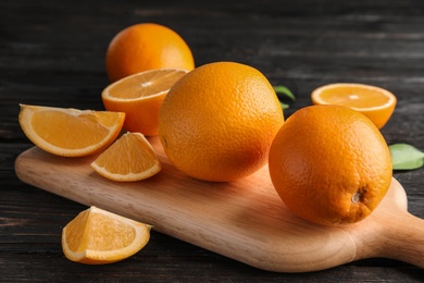 Photo of Fresh juicy oranges on wooden table. Healthy fruits
