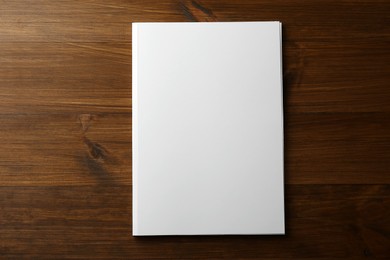 Photo of Blank paper brochure on wooden table, top view. Mockup for design