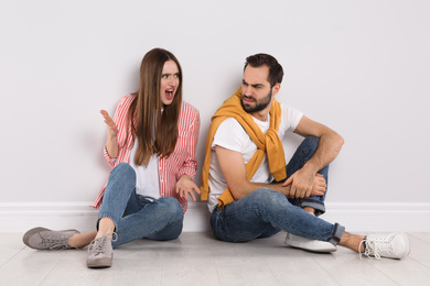 Photo of Unhappy young couple quarreling indoors. Relationship problems