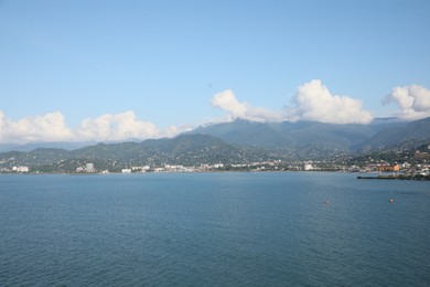 Photo of Picturesque view of city near sea and mountains