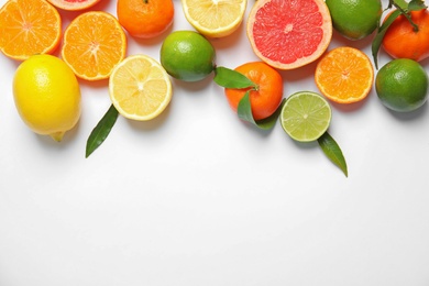 Photo of Different citrus fruits on white background, top view. Space for text