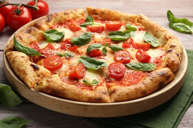 Photo of Delicious Margherita pizza on wooden table, closeup
