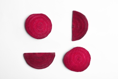 Photo of Composition with cut raw beets on white background, top view