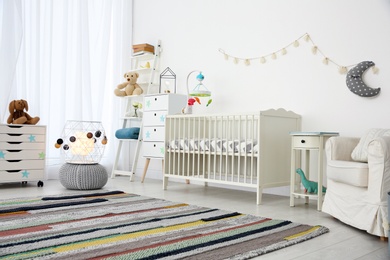 Photo of Cozy baby room interior with crib