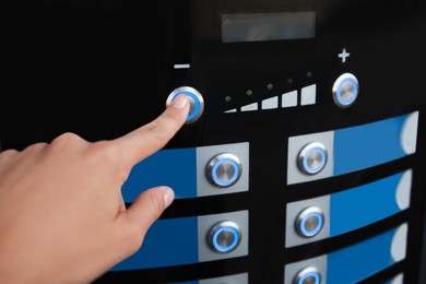 Photo of Woman choosing hot drink in coffee vending machine, closeup