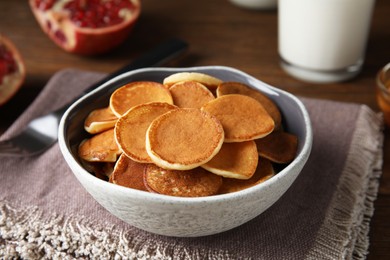 Photo of Delicious mini pancakes cereal served on table
