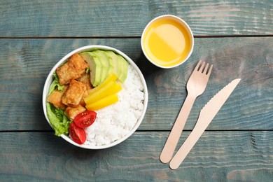 Photo of Healthy takeaway meal served with juice on blue wooden table, flat lay