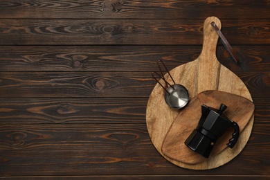 Set of modern cooking utensils on brown wooden table, top view. Space for text