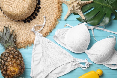Photo of Flat lay composition with beach objects on light blue wooden background