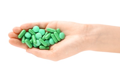 Photo of Woman holding color pills on white background, closeup