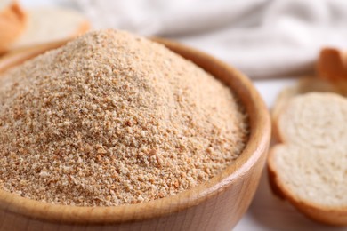 Photo of Fresh breadcrumbs in bowl on table, closeup