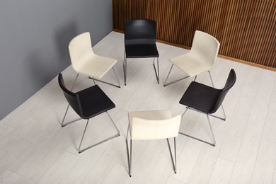 Photo of Chairs prepared for group therapy session in office. Meeting room interior