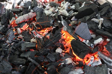 Many smoldering coals as background, closeup view
