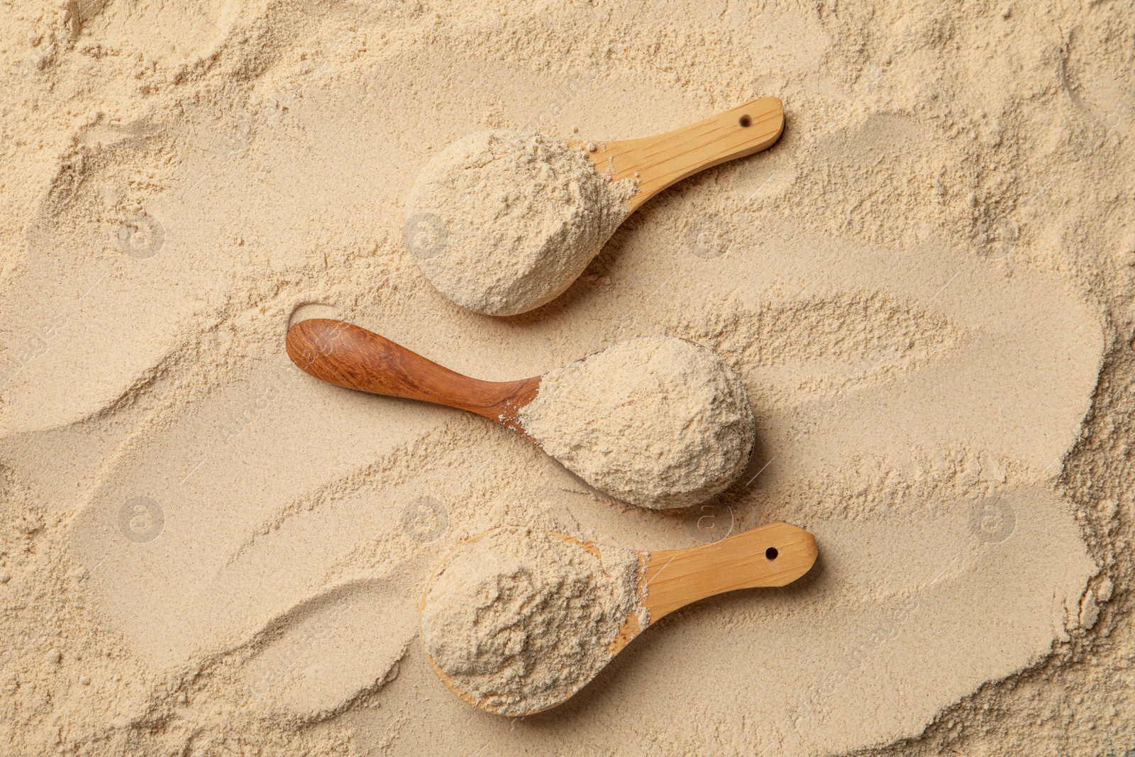 Photo of Buckwheat flour and wooden spoons, top view