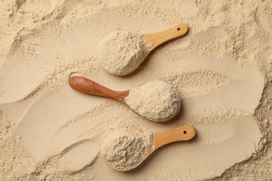 Photo of Buckwheat flour and wooden spoons, top view