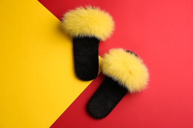 Photo of Pair of soft slippers on color background, flat lay