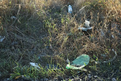 Photo of Different plastic garbage outdoors. Environmental pollution concept