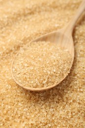 Photo of Spoon on granulated brown sugar, closeup view
