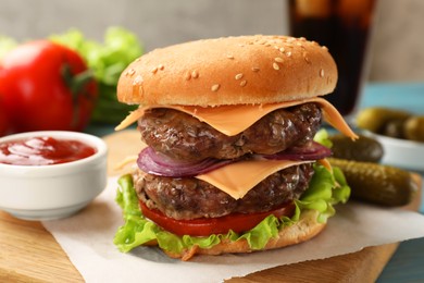 Photo of Tasty hamburger with patties, cheese and vegetables served on table, closeup