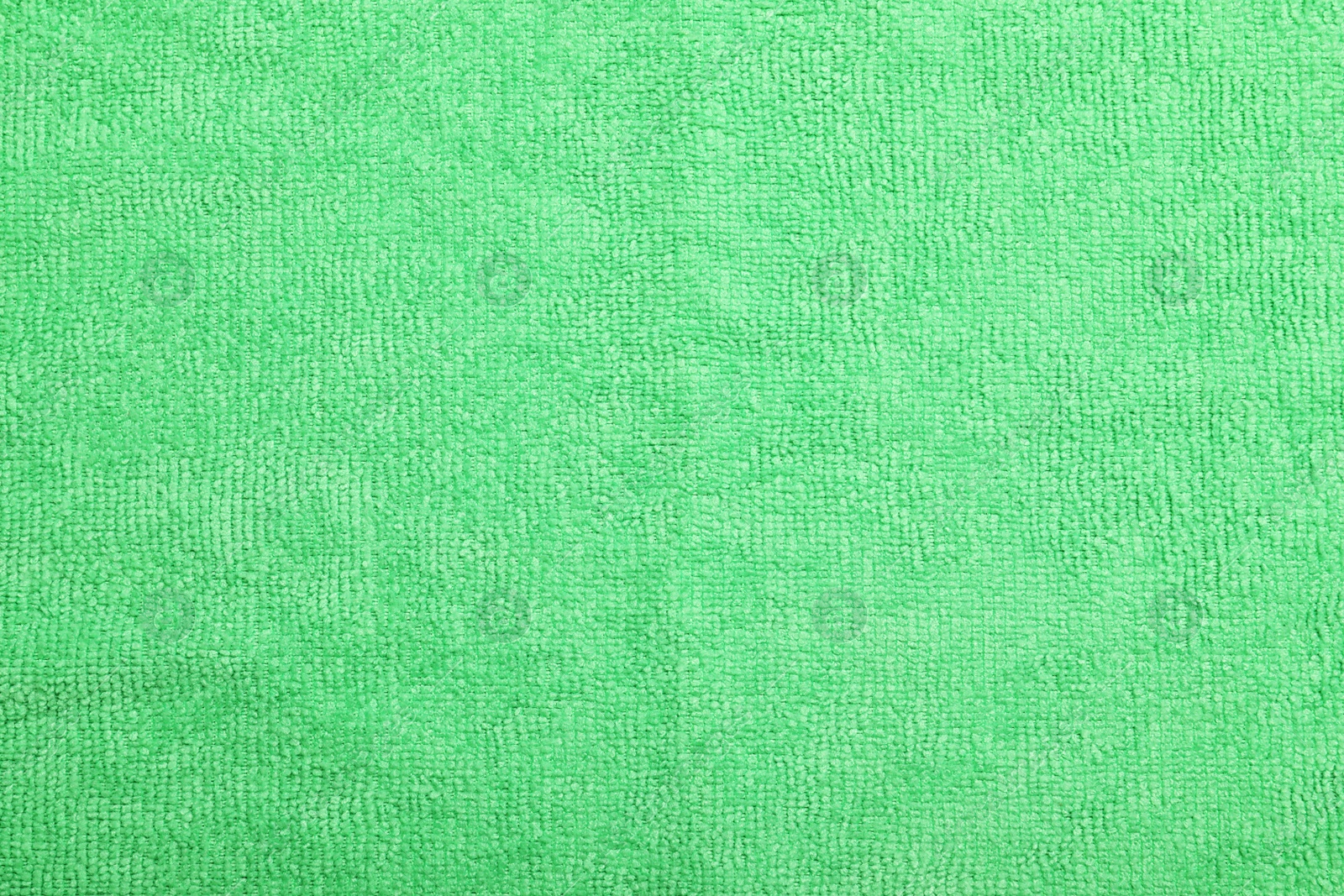 Photo of Light green microfiber cloth as background, top view