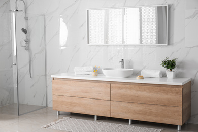 Modern mirror and vessel sink in stylish bathroom