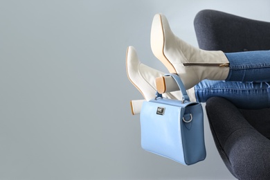 Photo of Woman wearing stylish leather shoes with bag indoors, closeup. Space for text