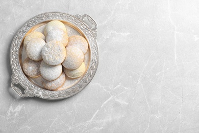 Photo of Dish of traditional cookies for Islamic holidays on table, top view with space for text. Eid Mubarak