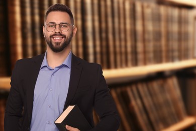 Image of Lawyer in glasses near shelves with books, space for text