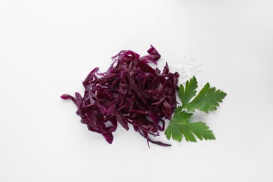 Photo of Tasty red cabbage sauerkraut with salt and parsley on white background, top view
