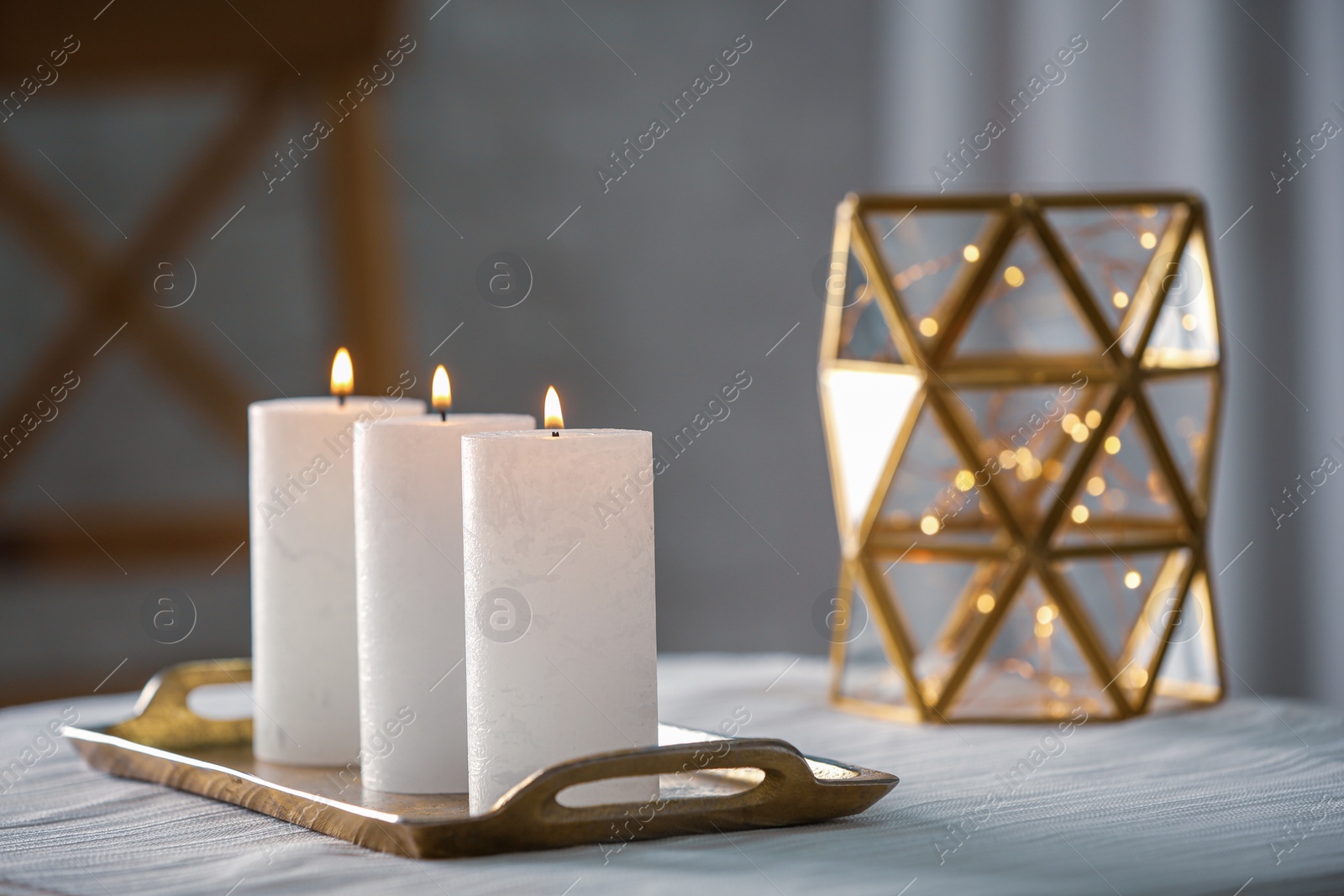 Photo of Burning candles on table indoors. Space for text