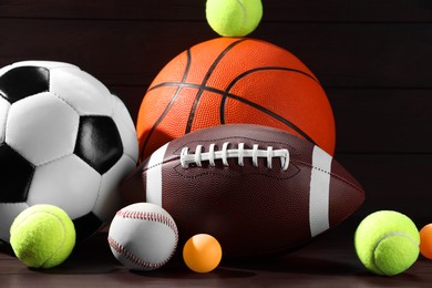 Photo of Many different sport balls on wooden background