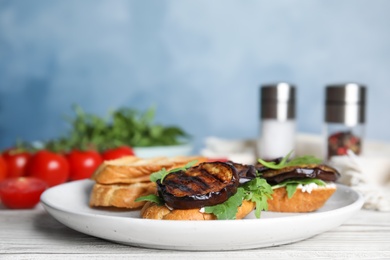 Delicious eggplant sandwiches on white wooden table